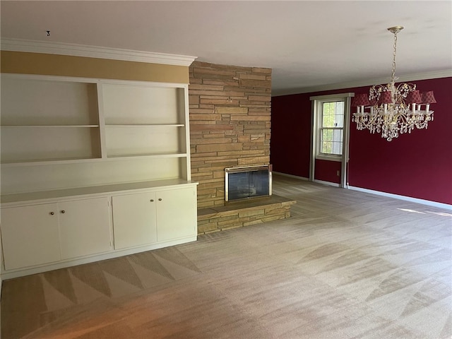 unfurnished living room featuring carpet flooring, a stone fireplace, crown molding, and an inviting chandelier