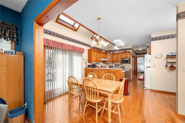 2 Rosewood Ct, Paris, IL 61944 - dining area featuring a skylight, light hardwood / wood-style flooring, and an inviting chandelier