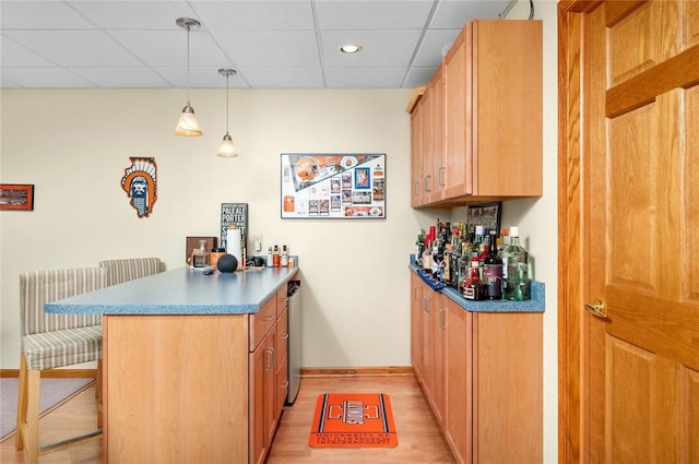 2 Rosewood Ct, Paris, IL 61944 - kitchen featuring kitchen peninsula, a breakfast bar, decorative light fixtures, and light hardwood / wood-style flooring