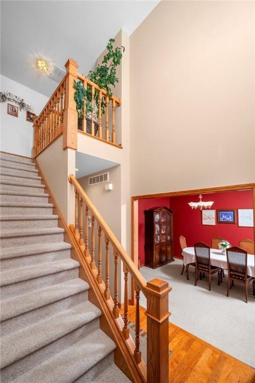2 Rosewood Ct, Paris, IL 61944 - staircase featuring hardwood / wood-style flooring and a notable chandelier