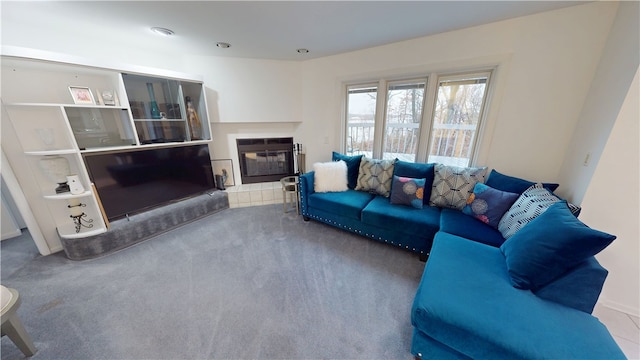 living room featuring carpet and a glass covered fireplace