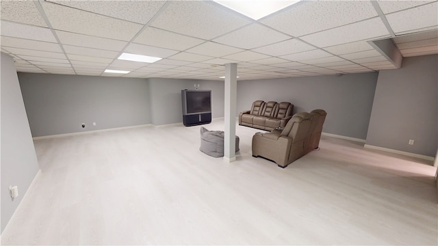 sitting room with a paneled ceiling, baseboards, and wood finished floors