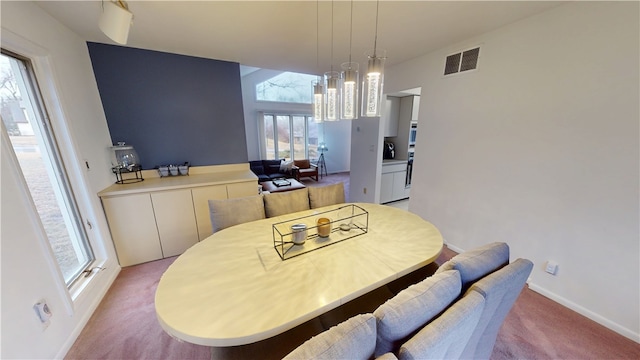 dining space with visible vents, light carpet, baseboards, and an inviting chandelier