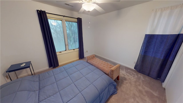 bedroom featuring carpet floors, baseboards, visible vents, and ceiling fan