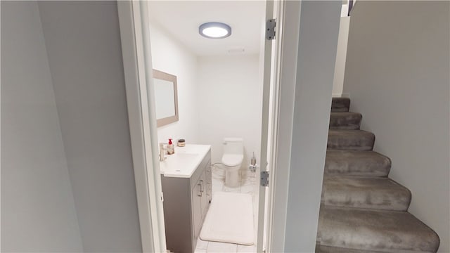 bathroom featuring vanity and toilet