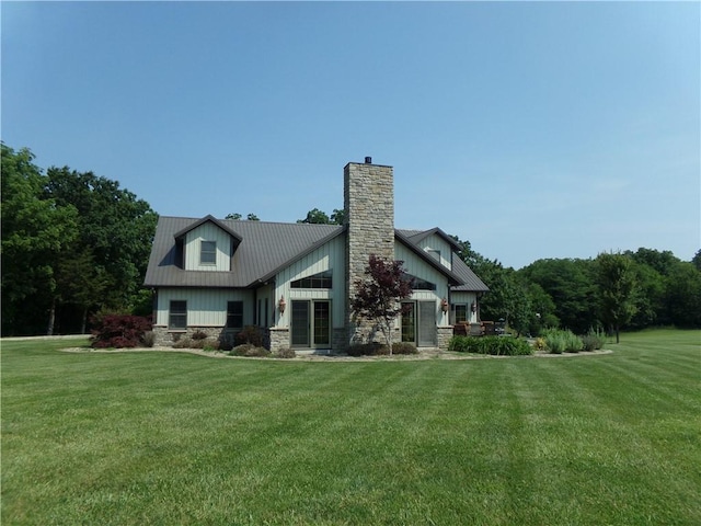 2277 County Highway 3, Findlay, IL 62534 - view of home's exterior featuring a chimney, a yard, a metal roof, and stone siding