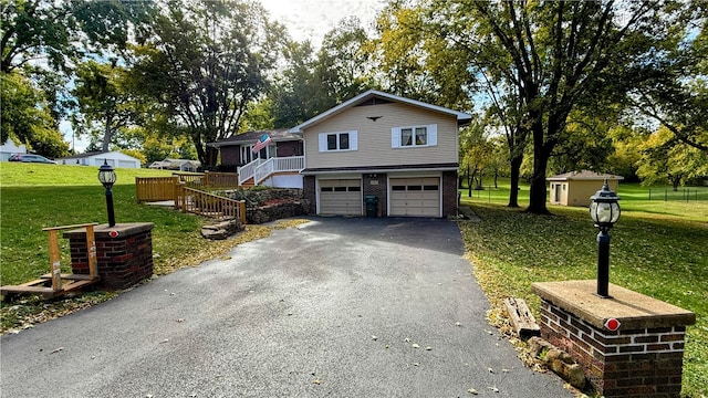 view of front of home featuring a garage and a front lawn