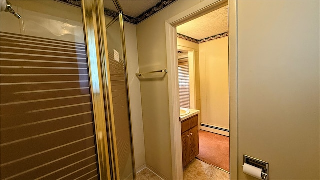 bathroom featuring a textured ceiling, vanity, a baseboard radiator, and a shower with door