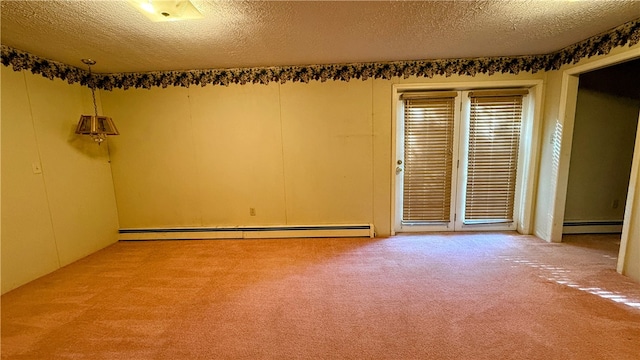 spare room featuring carpet flooring, a baseboard radiator, and a textured ceiling