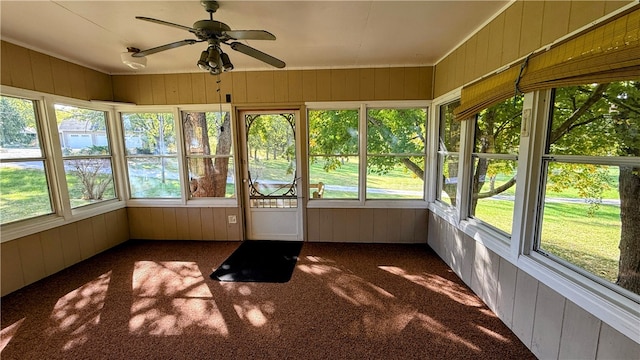 unfurnished sunroom featuring ceiling fan