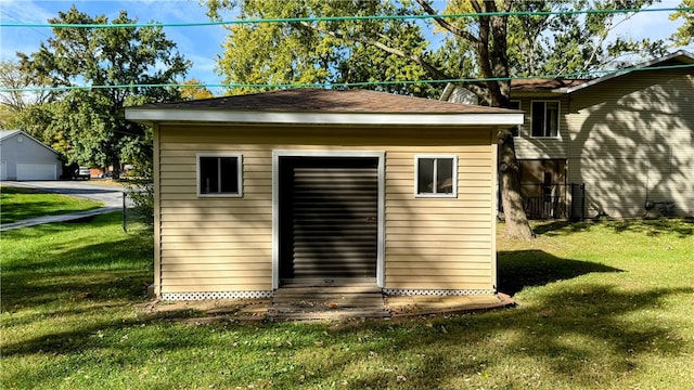 view of outbuilding featuring a lawn