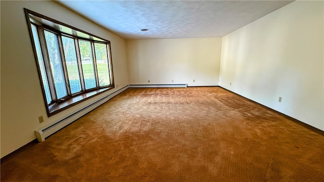 carpeted spare room with a textured ceiling and a baseboard heating unit