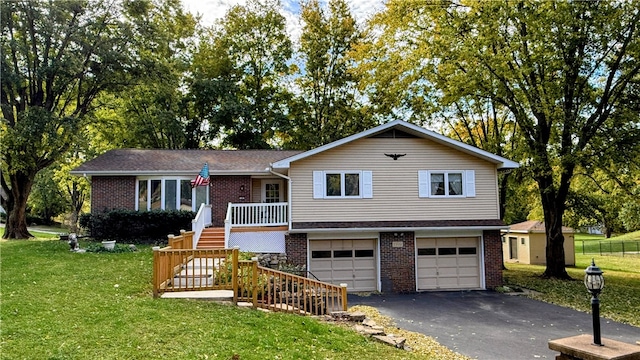 view of front of home featuring a front yard and a garage