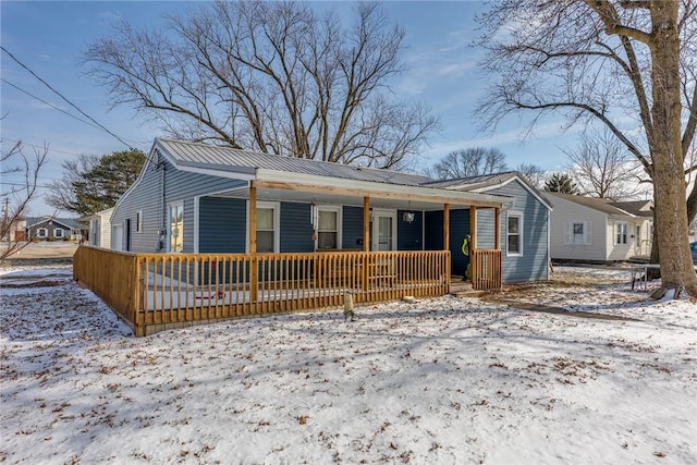 bungalow with a porch and metal roof