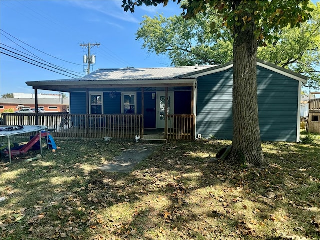 view of front of house with a porch and a trampoline