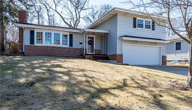 tri-level home featuring an attached garage, brick siding, driveway, and a chimney