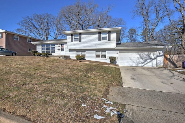 tri-level home with a garage and a front yard