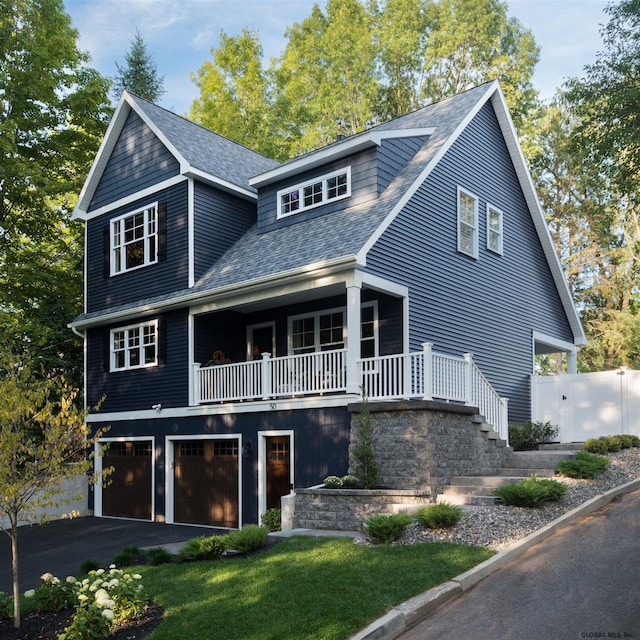 view of front of property featuring a porch and a garage