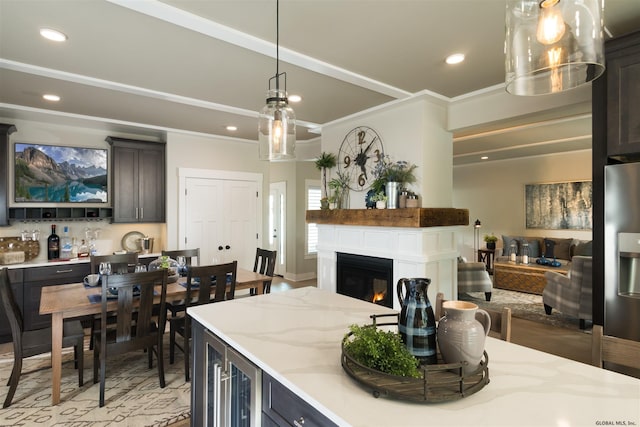 kitchen featuring light stone countertops, hanging light fixtures, wine cooler, and crown molding