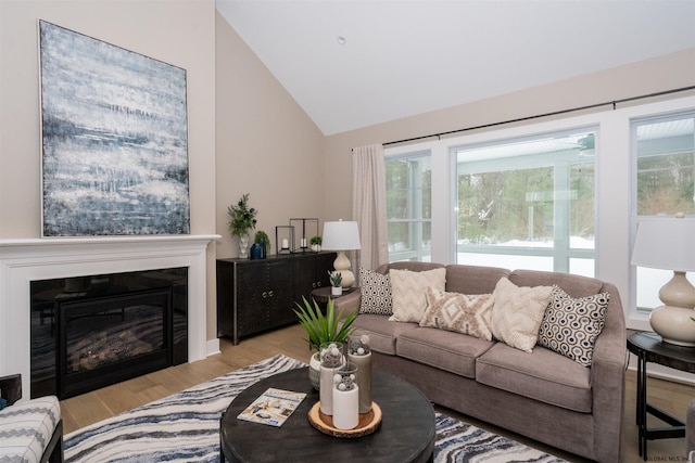 living room with high vaulted ceiling and light hardwood / wood-style flooring