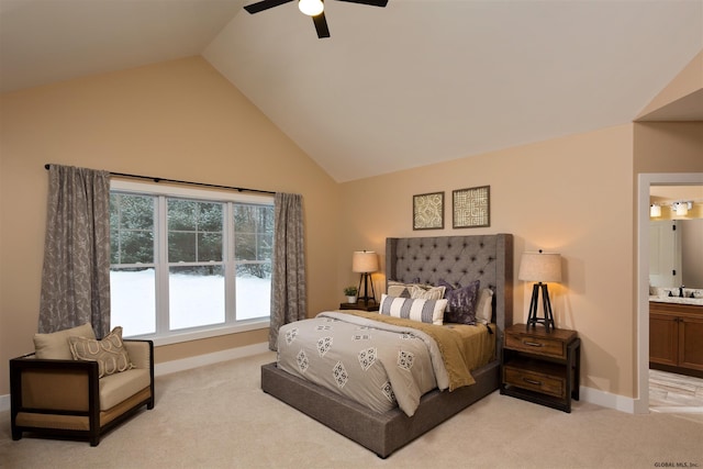 carpeted bedroom featuring ceiling fan, sink, ensuite bathroom, and high vaulted ceiling