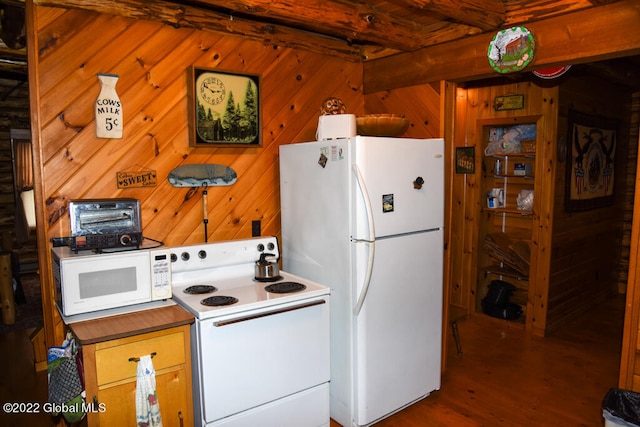 kitchen with dark hardwood / wood-style floors, beam ceiling, white appliances, and wooden walls