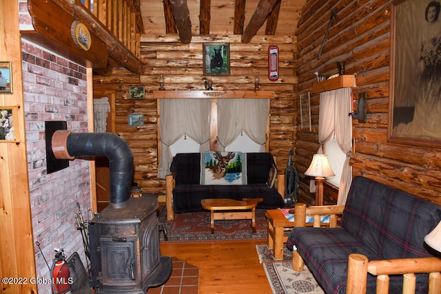 living room with rustic walls, dark hardwood / wood-style floors, and a wood stove