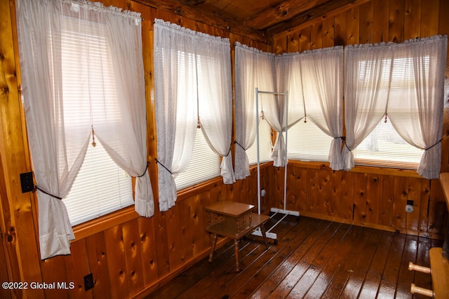 misc room with dark hardwood / wood-style flooring and wooden walls