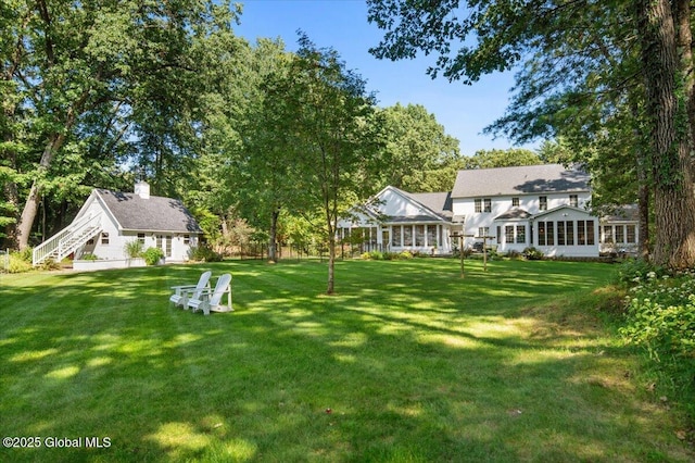 view of yard with a sunroom
