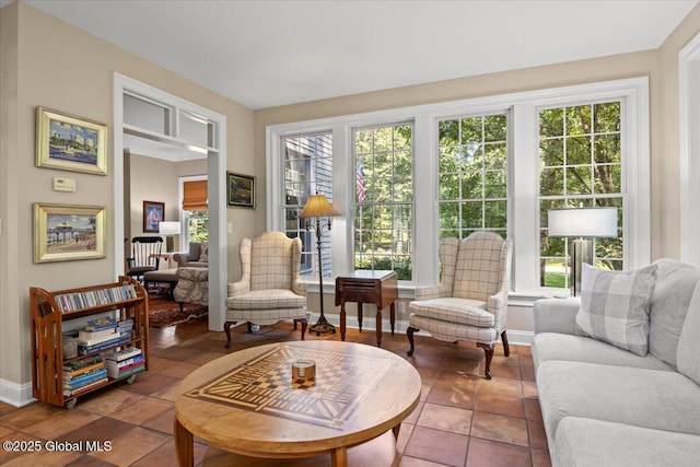 living room with tile patterned flooring, plenty of natural light, and baseboards