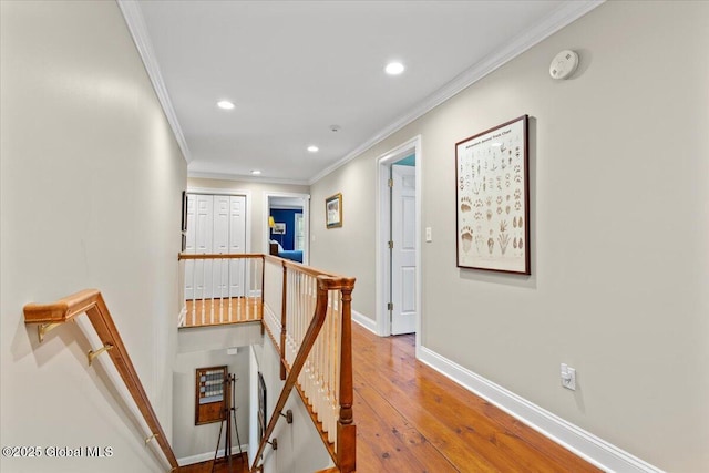 corridor featuring an upstairs landing, crown molding, recessed lighting, baseboards, and hardwood / wood-style flooring