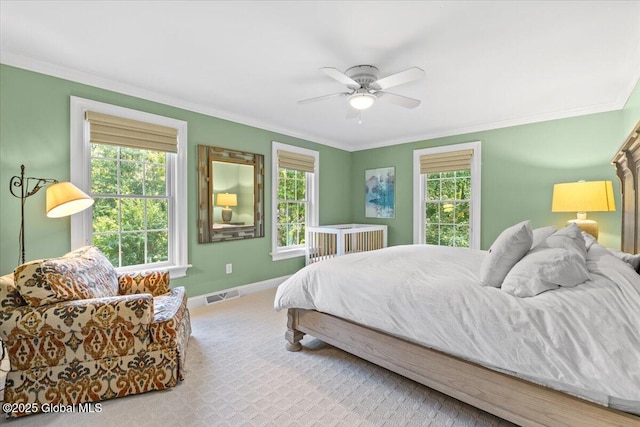 bedroom featuring visible vents, ornamental molding, and carpet