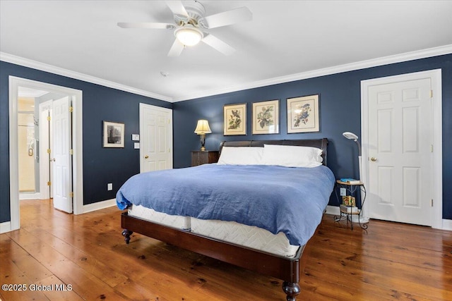 bedroom featuring a ceiling fan, hardwood / wood-style flooring, baseboards, and crown molding