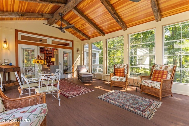 sunroom with a ceiling fan and beamed ceiling