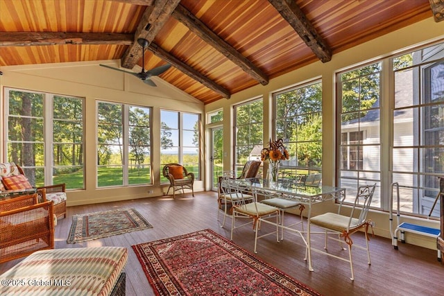 sunroom / solarium featuring vaulted ceiling with beams, a deck, and plenty of natural light