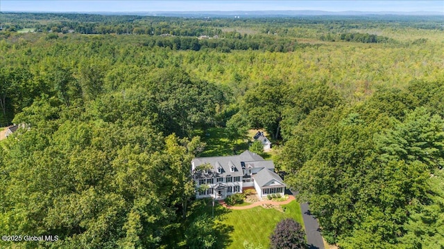 birds eye view of property featuring a view of trees