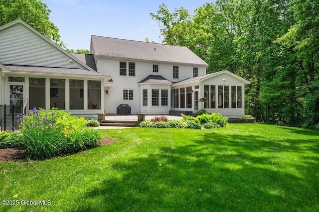 5 Winding Brook Dr, Saratoga Springs, NY 12866 - rear view of property featuring a sunroom, a lawn, and roof with shingles