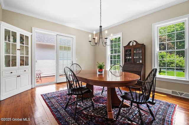 5 Winding Brook Dr, Saratoga Springs, NY 12866 - dining room featuring a chandelier, healthy amount of natural light, ornamental molding, and light wood-type flooring