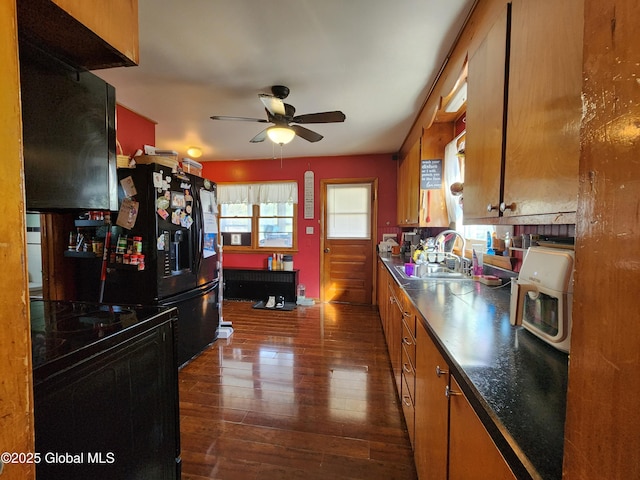 269 Broadway, Menands, NY 12204 - kitchen featuring a ceiling fan, dark wood finished floors, a sink, brown cabinets, and dark countertops