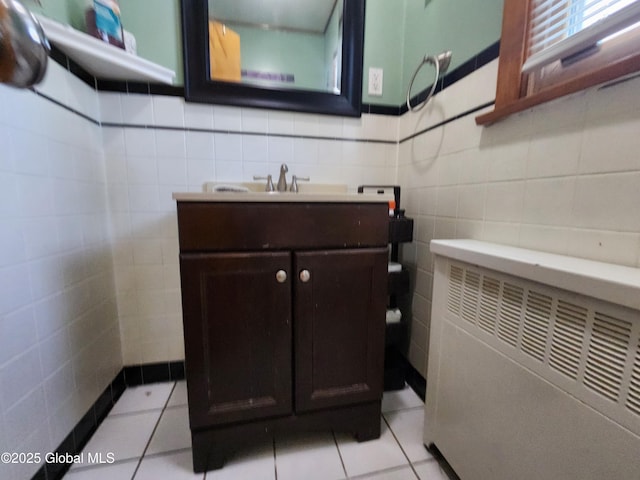 269 Broadway, Menands, NY 12204 - bathroom with tile walls, vanity, and tile patterned flooring