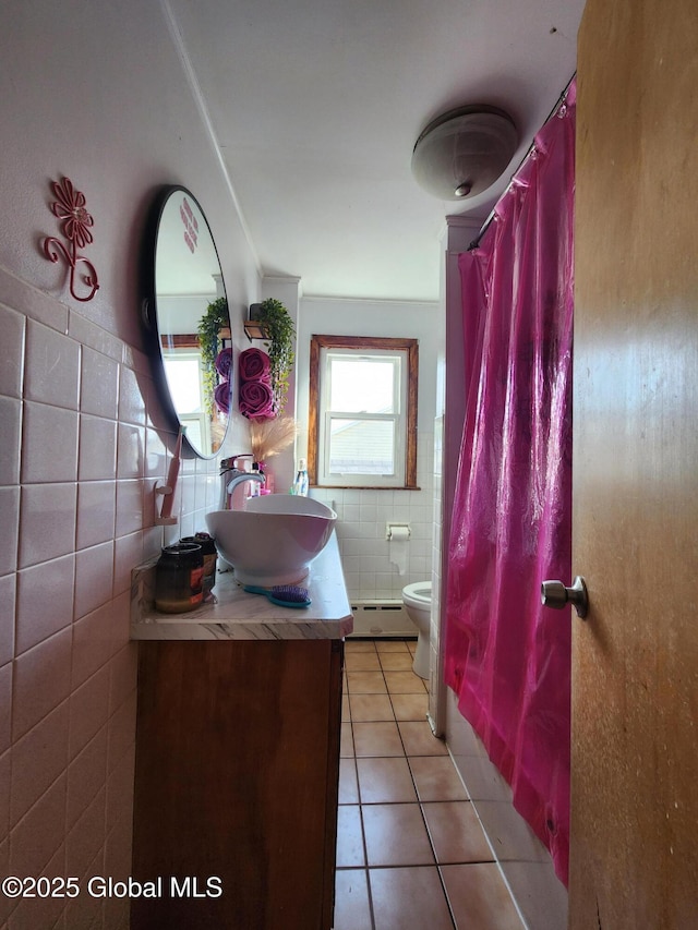 269 Broadway, Menands, NY 12204 - bathroom featuring tile walls, tile patterned flooring, toilet, baseboard heating, and vanity