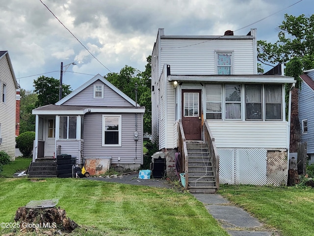 269 Broadway, Menands, NY 12204 - back of house featuring a lawn and a sunroom
