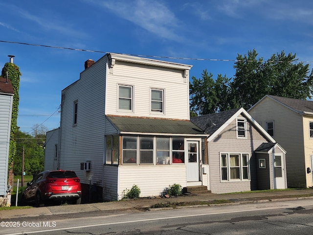 269 Broadway, Menands, NY 12204 - view of front of home with entry steps, a chimney, roof with shingles, and a sunroom
