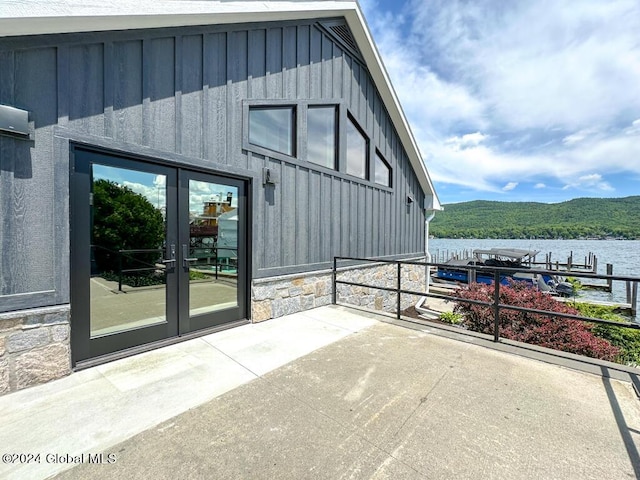 view of patio / terrace featuring a water view and french doors