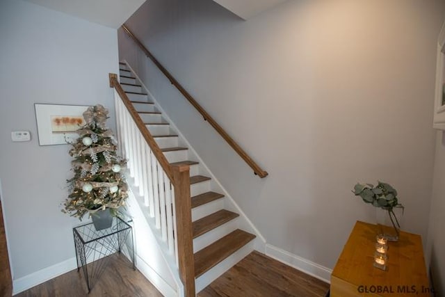 stairs with dark wood-type flooring