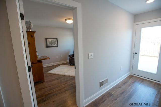 hallway featuring dark hardwood / wood-style floors and a wealth of natural light