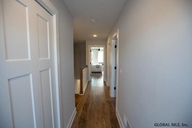 corridor with dark hardwood / wood-style flooring