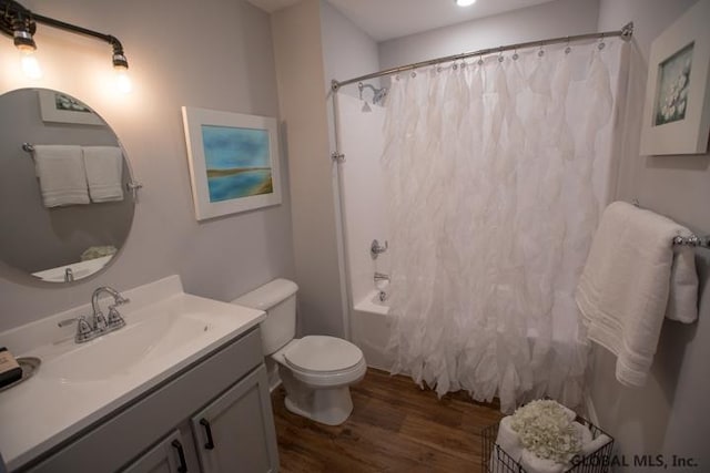 full bathroom with toilet, hardwood / wood-style floors, shower / bath combo, and vanity