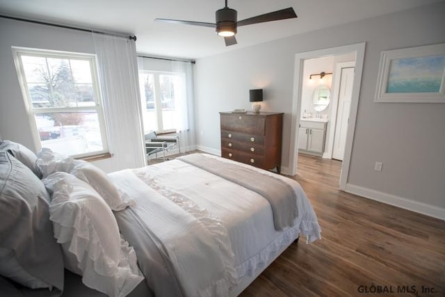 bedroom featuring connected bathroom, dark hardwood / wood-style flooring, and ceiling fan