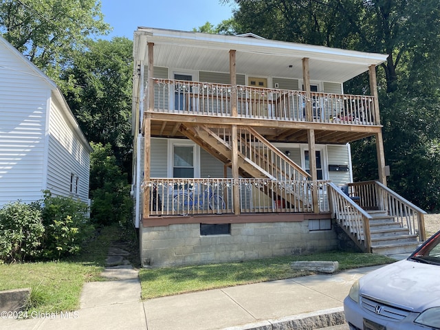 view of front of home with stairs and covered porch